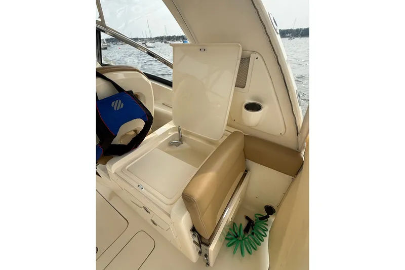 Slide: The Image of 2018 Scout 275 Dorado boat interior with seating and storage compartment open. - 22