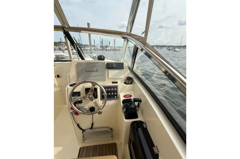 Slide: The Image of 2018 Scout 275 Dorado helm with Garmin navigation, steering wheel, and control panel. - 15