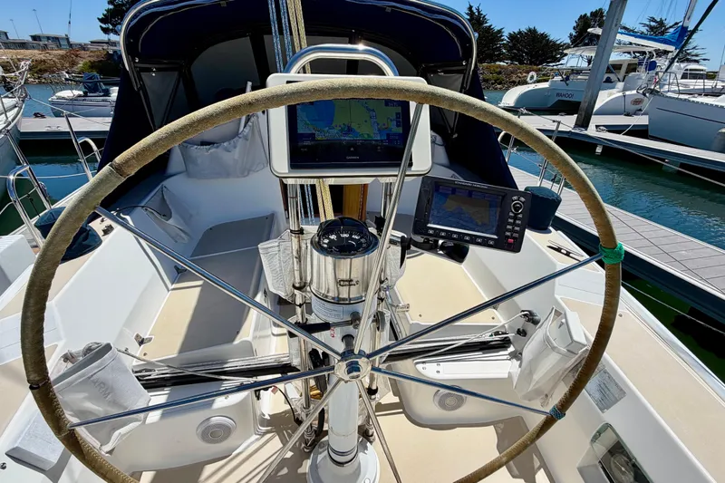 Slide: The Image of Cockpit of a 2001 J Boats J/32 sailboat with navigation equipment and steering wheel. - 54