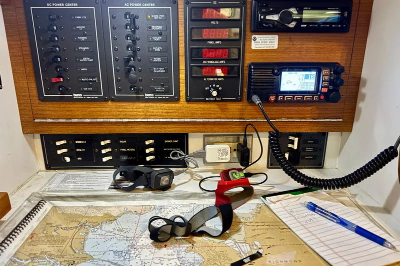 Slide: The Image of Navigation station on a 2001 J Boats J/32, featuring control panels and nautical charts. - 23
