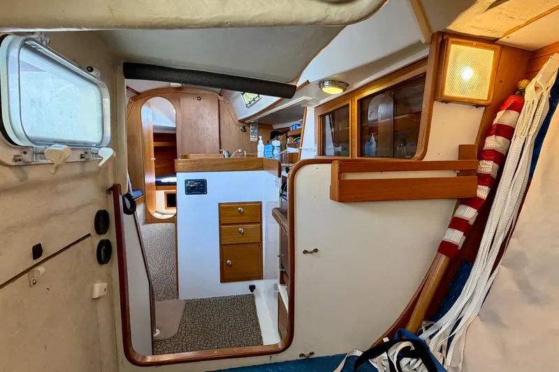 Slide: The Image of Interior of a 2001 J Boats J/32 sailboat, featuring wooden cabinetry and nautical decor. - 27