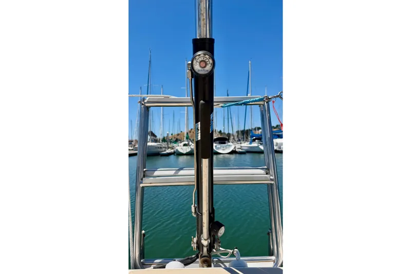 Slide: The Image of 2001 J Boats J/32 sailboat with marina view, featuring a stainless steel ladder and clear blue sky. - 47