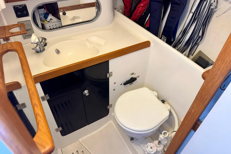Slide: The Image of 2001 J Boats J/32 yacht bathroom with sink, mirror, and marine toilet. - 34