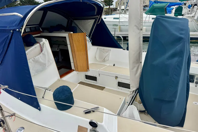 Slide: The Image of 2001 J Boats J/32 sailboat cockpit with blue covers and open cabin entrance. - 13