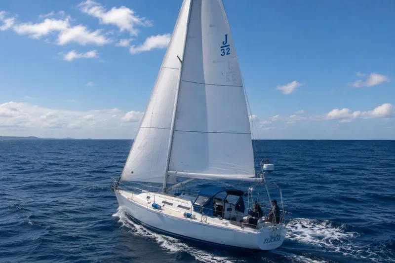 The Image of 2001 J Boats J/32 sailing on open ocean under clear blue sky. - 0