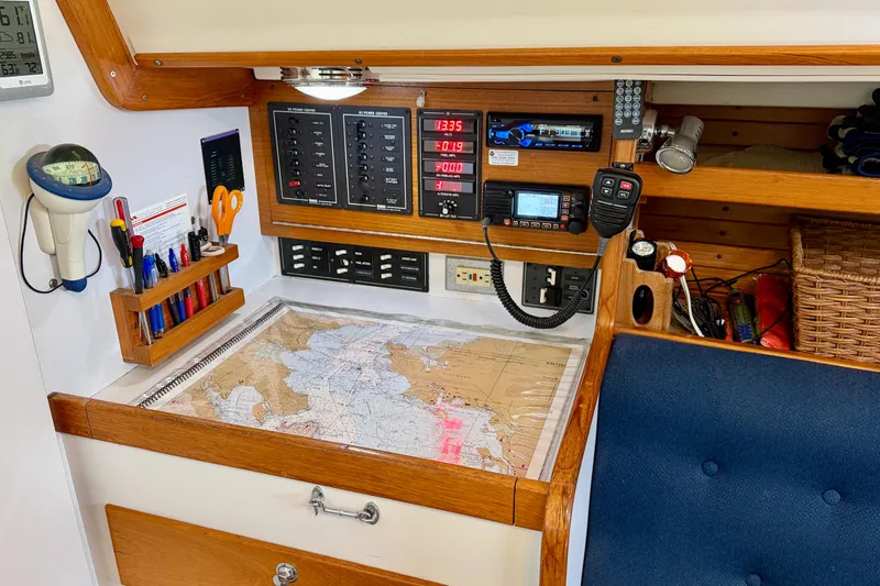 Slide: The Image of Navigation station on a 2001 J Boats J/32 sailboat with charts and communication equipment. - 24