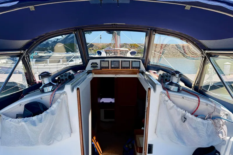 Slide: The Image of Cockpit view of a 2001 J Boats J/32 sailboat, featuring navigation instruments and winches. - 51