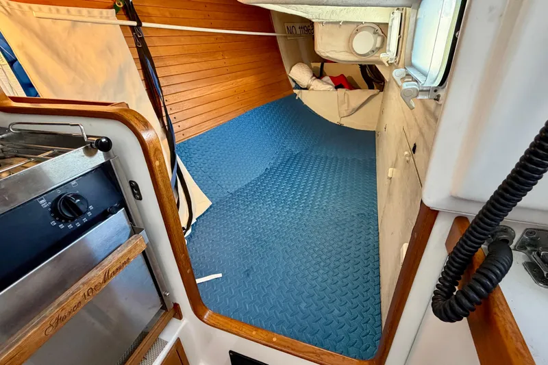 Slide: The Image of Interior of a 2001 J Boats J/32 sailboat with blue flooring and wooden accents. - 31