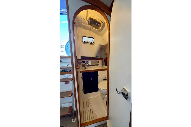 Slide: The Image of 2001 J Boats J/32 sailboat bathroom interior with wooden trim and compact design. - 32