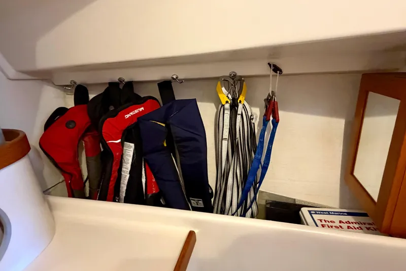Slide: The Image of Storage area on a 2001 J Boats J/32, featuring life jackets and sailing gear. - 33