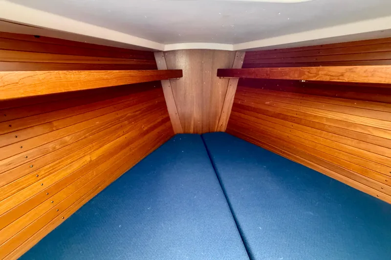 Slide: The Image of Cozy wooden interior of 2001 J Boats J/32 sailboat cabin with blue cushions. - 30