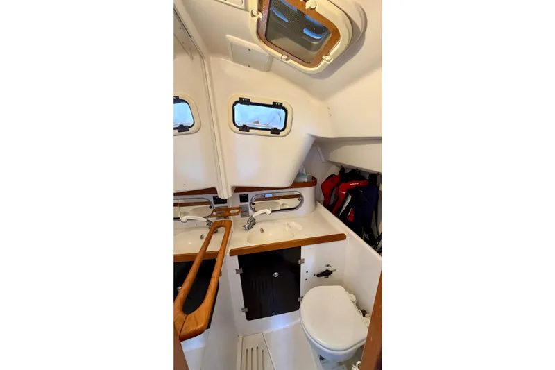 Slide: The Image of 2001 J Boats J/32 yacht interior bathroom with sink, toilet, and storage. - 36