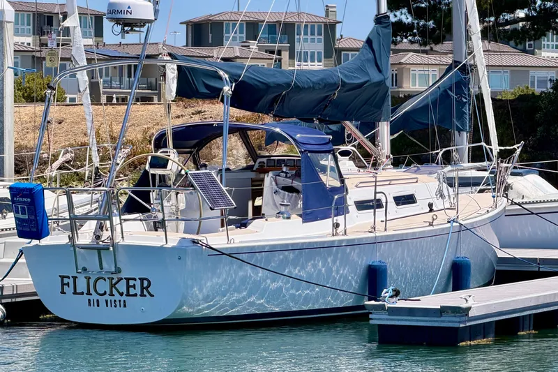 Slide: The Image of 2001 J Boats J/32 sailboat named "Flicker" docked at marina. - 8