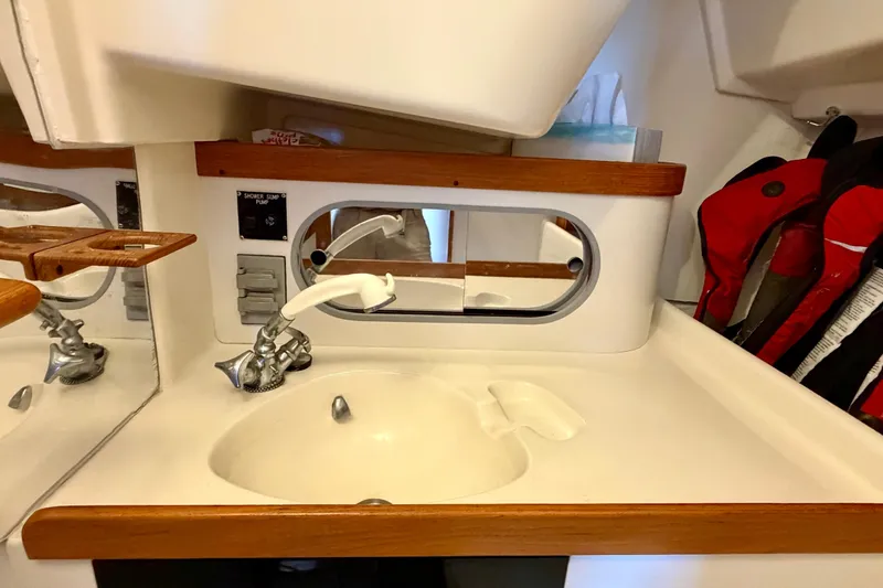 Slide: The Image of Interior of 2001 J Boats J/32 sailboat featuring a compact sink and faucet setup. - 35
