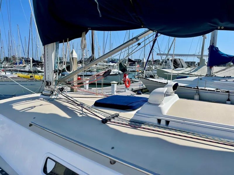 Slide: The Image of The deck of a 2001 J/32 with sails and rigging in a marina. - 9