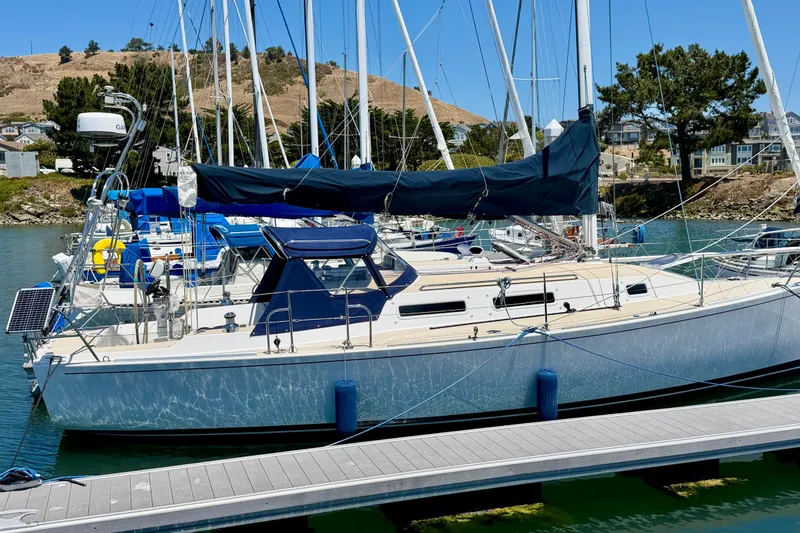 Slide: The Image of 2001 J Boats J/32 sailboat docked in a marina, surrounded by other vessels. - 50