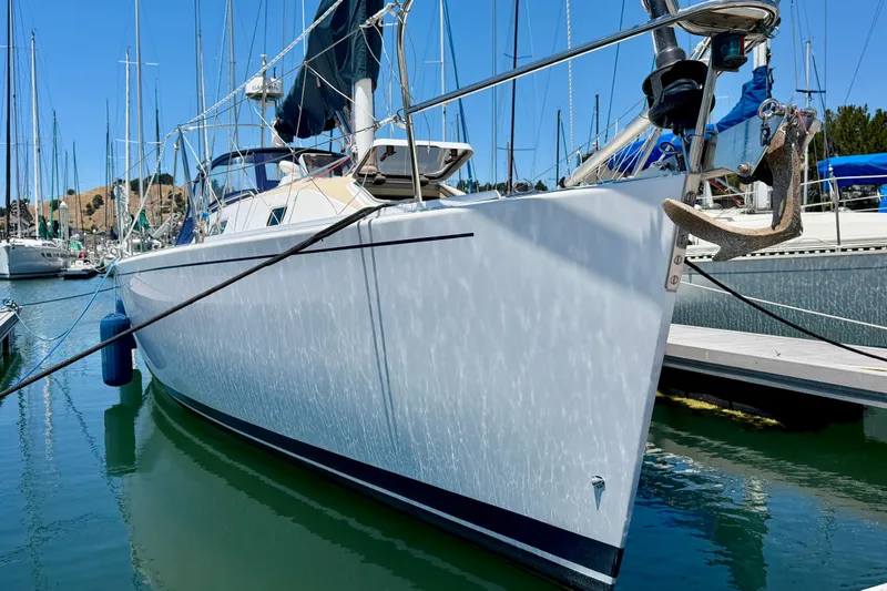 Slide: The Image of 2001 J Boats J/32 sailboat docked in a marina, clear blue sky background. - 46