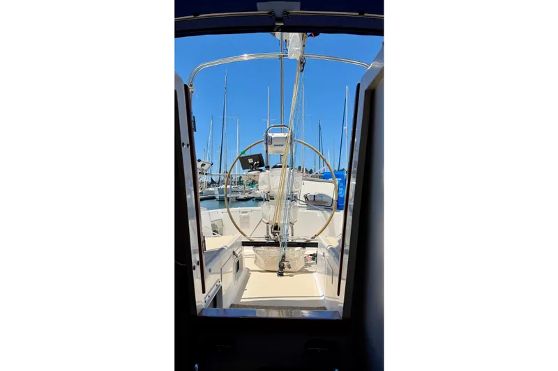 Slide: The Image of 2001 J Boats J/32 sailboat cockpit view with steering wheel, docked in marina. - 52