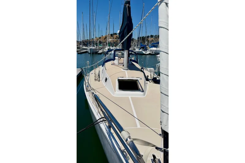 Slide: The Image of 2001 J Boats J/32 sailboat docked in a marina, showcasing its deck and rigging. - 45
