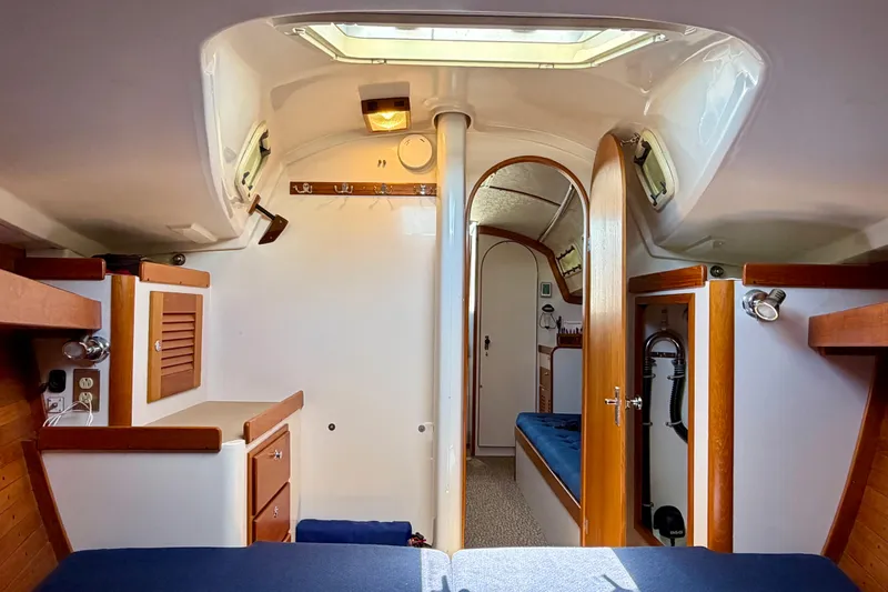 Slide: The Image of Interior of a 2001 J Boats J/32 sailboat, featuring cozy wooden cabinetry and seating. - 20