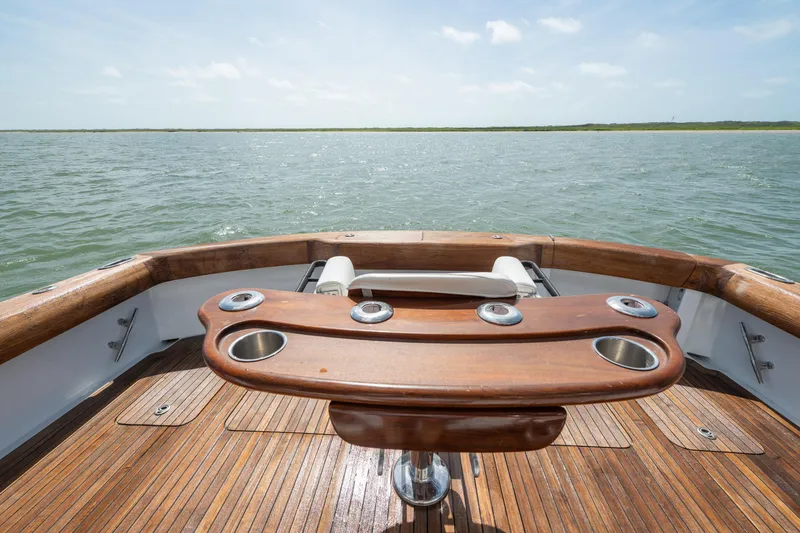 Slide: The Image of 2003 Hatteras 60 Convertible yacht deck with ocean view and wooden fishing station. - 18