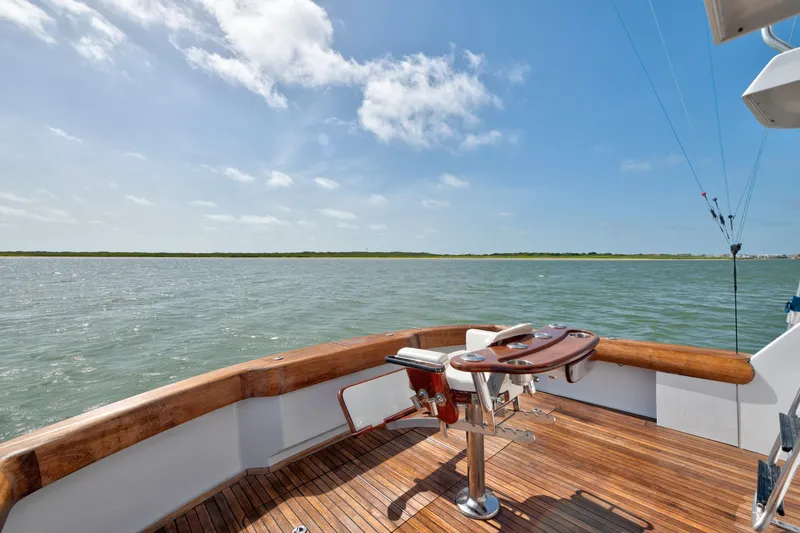 Slide: The Image of 2003 Hatteras 60 Convertible yacht deck with ocean view and fishing chair. - 17