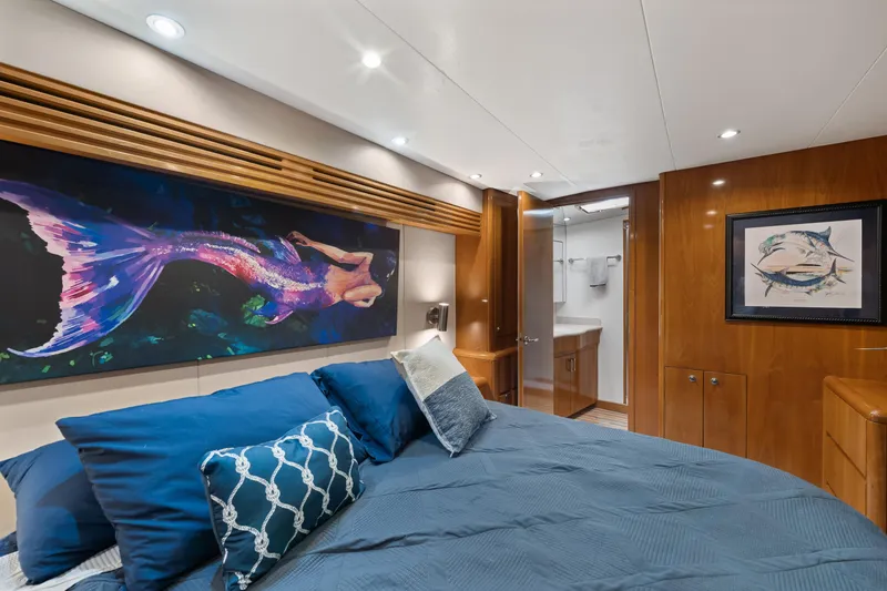 Slide: The Image of Luxurious 2003 Hatteras 60 Convertible yacht bedroom with mermaid artwork and elegant decor. - 32