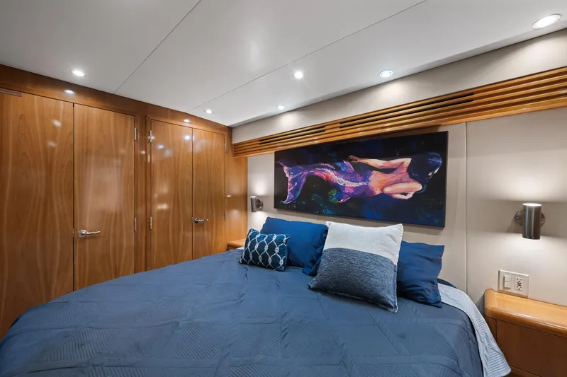 Slide: The Image of Luxurious bedroom interior of 2003 Hatteras 60 Convertible yacht with elegant wood paneling. - 30
