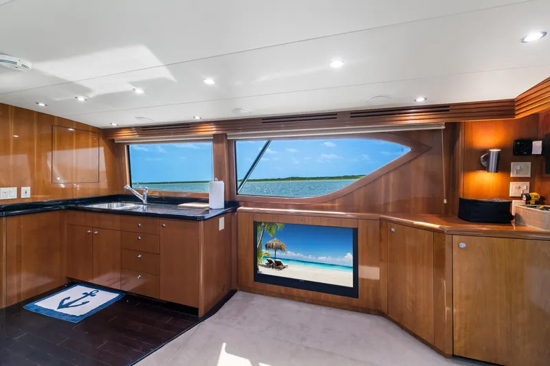 Slide: The Image of Luxurious interior of 2003 Hatteras 60 Convertible yacht with ocean view through large windows. - 21