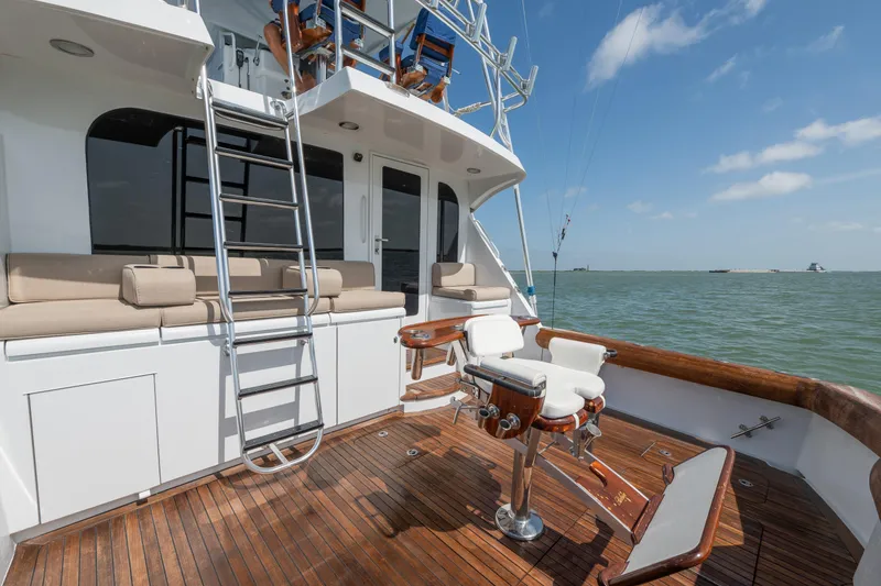 Slide: The Image of 2003 Hatteras 60 Convertible yacht deck with seating and fishing chair, ocean view. - 15