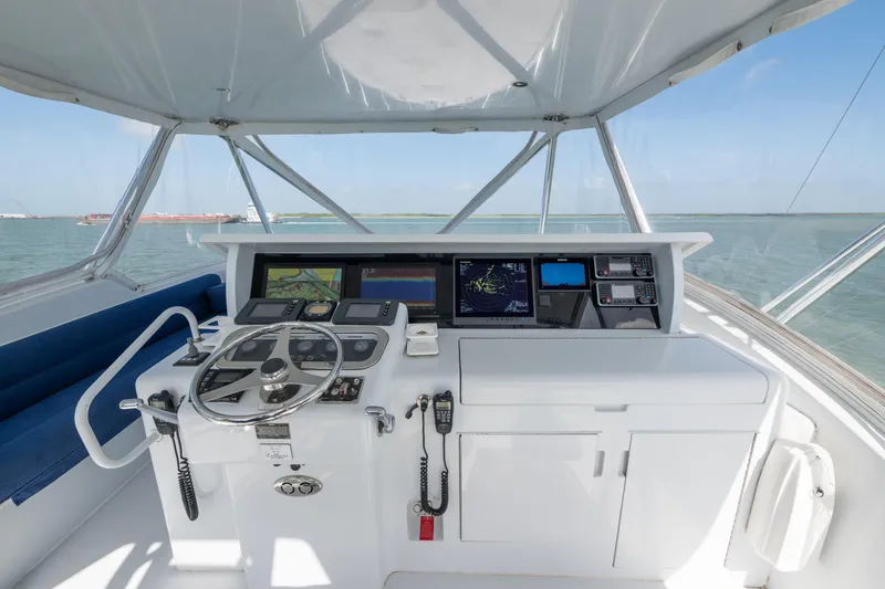 Slide: The Image of Helm of 2003 Hatteras 60 Convertible yacht with navigation equipment and ocean view. - 5