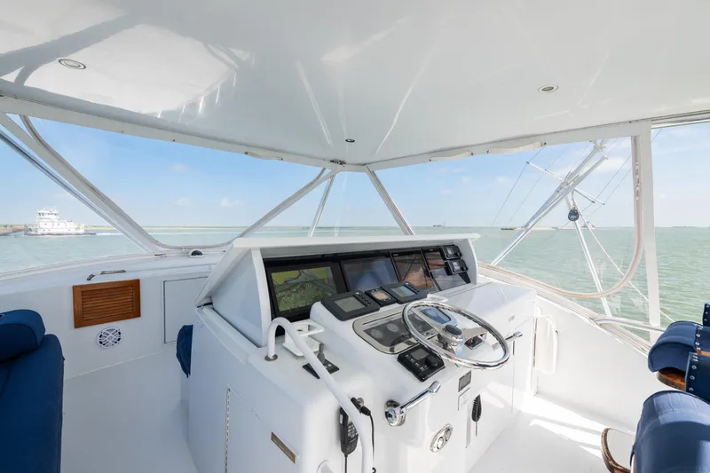 Slide: The Image of Helm of 2003 Hatteras 60 Convertible yacht with ocean view and navigation equipment. - 4