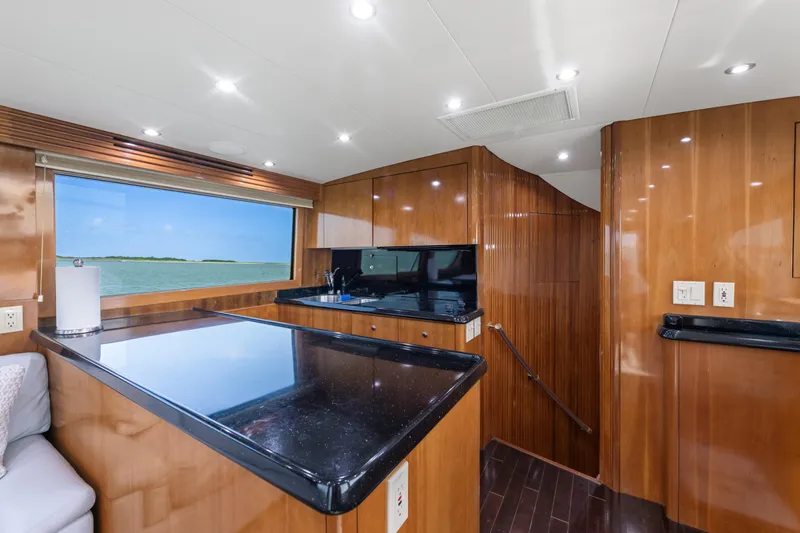 Slide: The Image of Luxurious interior of 2003 Hatteras 60 Convertible yacht with sleek wood finishes and ocean view. - 24