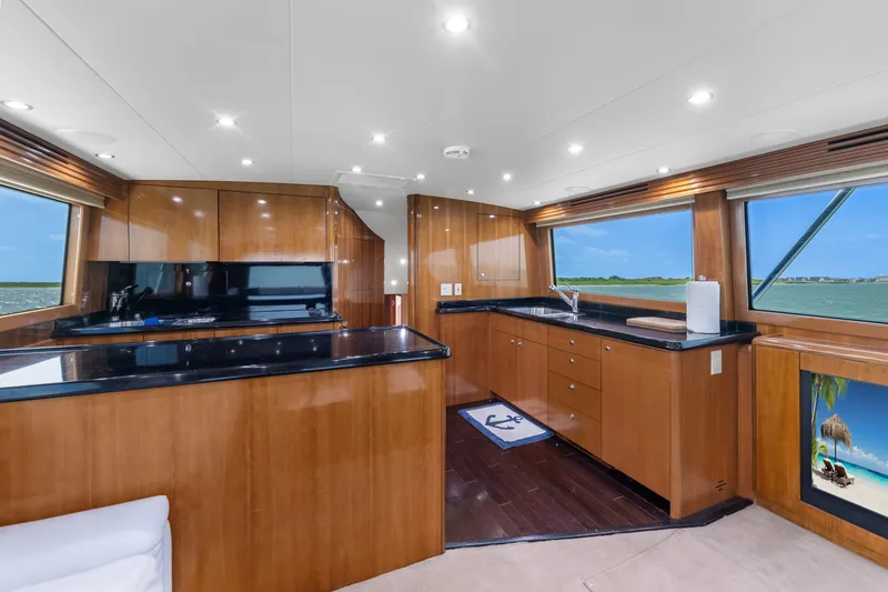 Slide: The Image of Luxurious interior of 2003 Hatteras 60 Convertible yacht with sleek wood finishes and ocean views. - 23