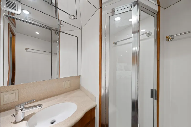 Slide: The Image of Luxurious bathroom on 2003 Hatteras 60 Convertible yacht with modern fixtures and glass shower. - 40