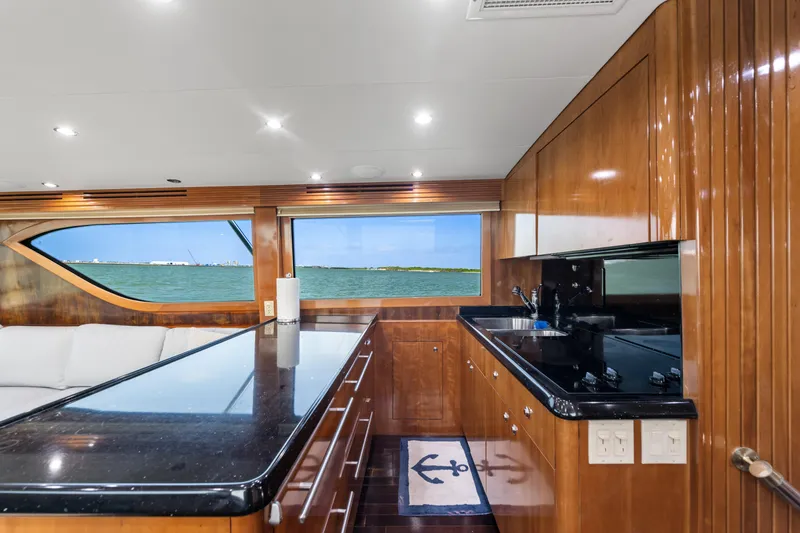Slide: The Image of Luxurious 2003 Hatteras 60 Convertible yacht interior with sleek kitchen and ocean view. - 25