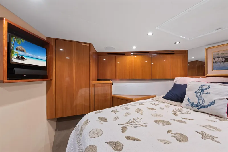 Slide: The Image of Luxurious cabin interior of 2003 Hatteras 60 Convertible yacht with cozy bedding and wood finishes. - 38