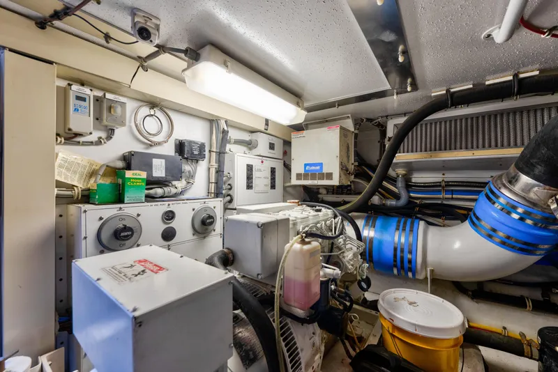 Slide: The Image of Engine room of 2003 Hatteras 60 Convertible yacht, featuring mechanical and electrical systems. - 47