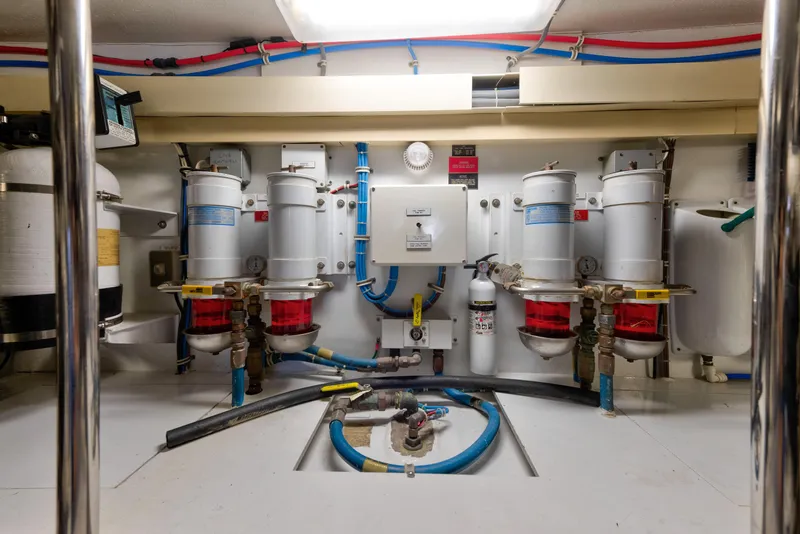 Slide: The Image of Engine room of 2003 Hatteras 60 Convertible yacht with fuel filters and fire extinguisher. - 42