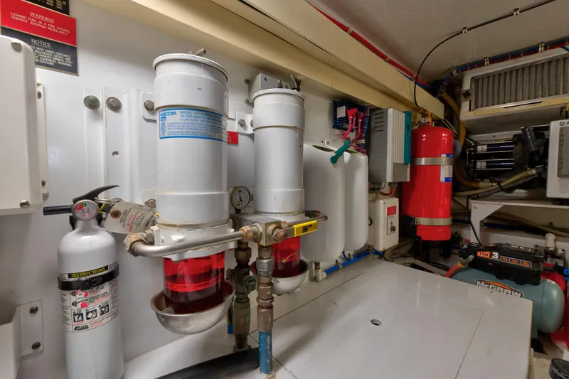 Slide: The Image of Engine room of 2003 Hatteras 60 Convertible yacht with fuel filters and safety equipment. - 43