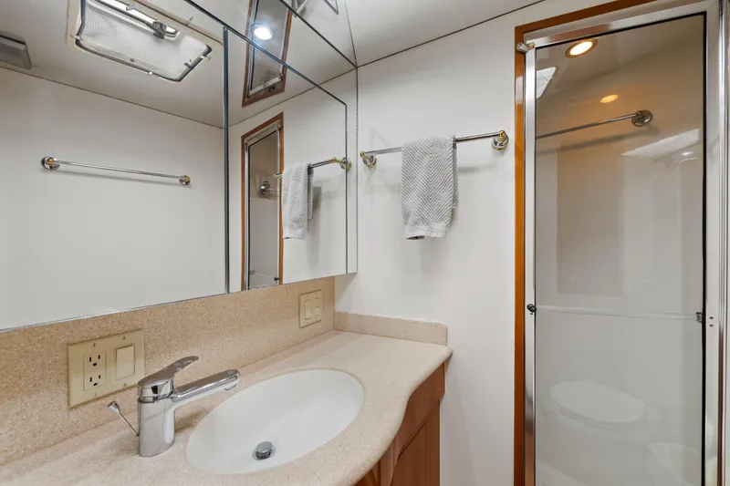 Slide: The Image of Luxurious bathroom in 2003 Hatteras 60 Convertible yacht with modern fixtures and shower. - 33