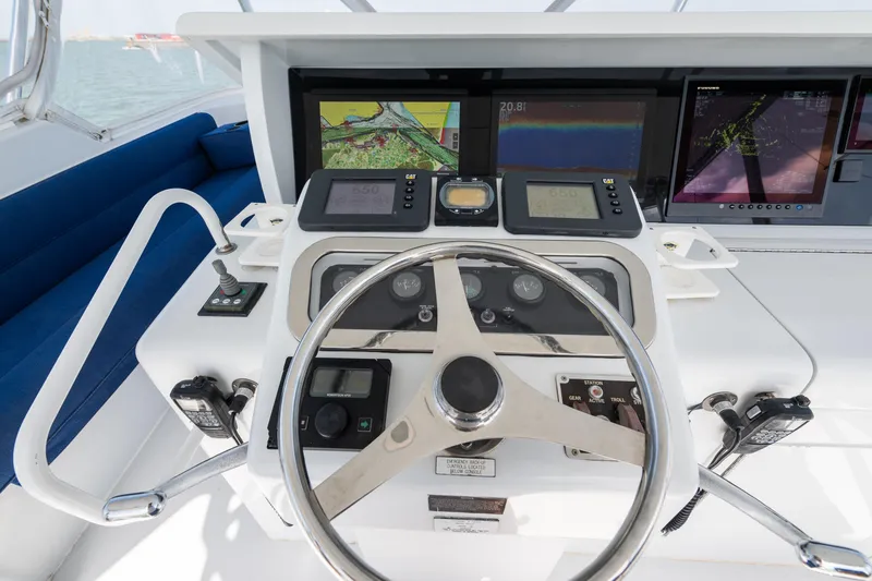 Slide: The Image of Helm of 2003 Hatteras 60 Convertible yacht with navigation screens and controls. - 6
