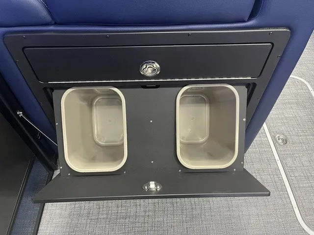 Slide: The Image of A built-in trash bin with two compartments in a boat, surrounded by blue upholstery. - 9