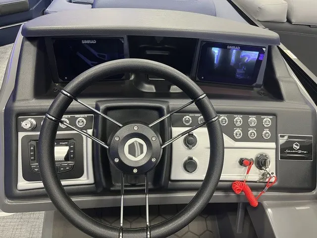 Slide: The Image of The image shows the helm of a South Bay 525RS 3.0 boat with modern instruments. - 6