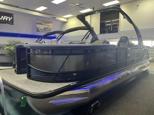 The Image of A modern pontoon boat with sleek lines and a spacious deck, displayed in a showroom. - 1