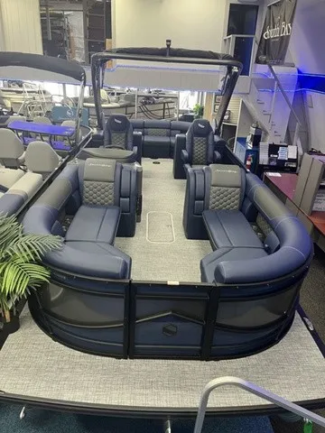 Slide: The Image of A luxurious pontoon boat with blue upholstery and modern design, displayed in a showroom. - 3