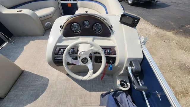 Slide: The Image of The image shows the helm of a 2017 Berkshire 17CL 2.0 boat with a steering wheel and gauges. - 6