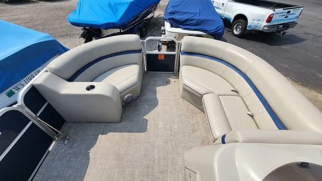 Slide: The Image of The image shows the interior of a 2017 Berkshire 17CL 2.0 pontoon boat with beige seating. - 7