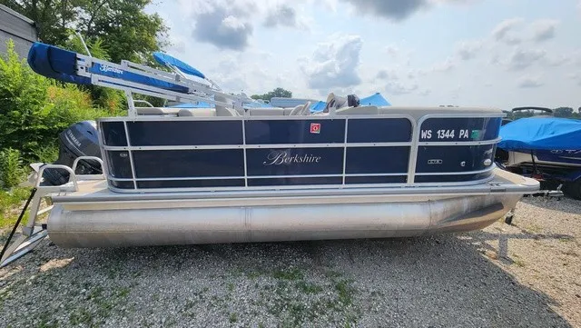The Image of A blue and white Berkshire pontoon boat, model 17CL 2.0, year 2017, on a gravel lot. - 1