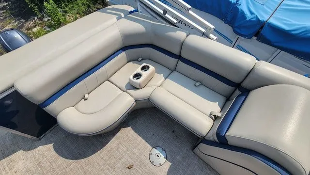 Slide: The Image of The image shows a beige and blue seating area on a boat with cup holders. - 9